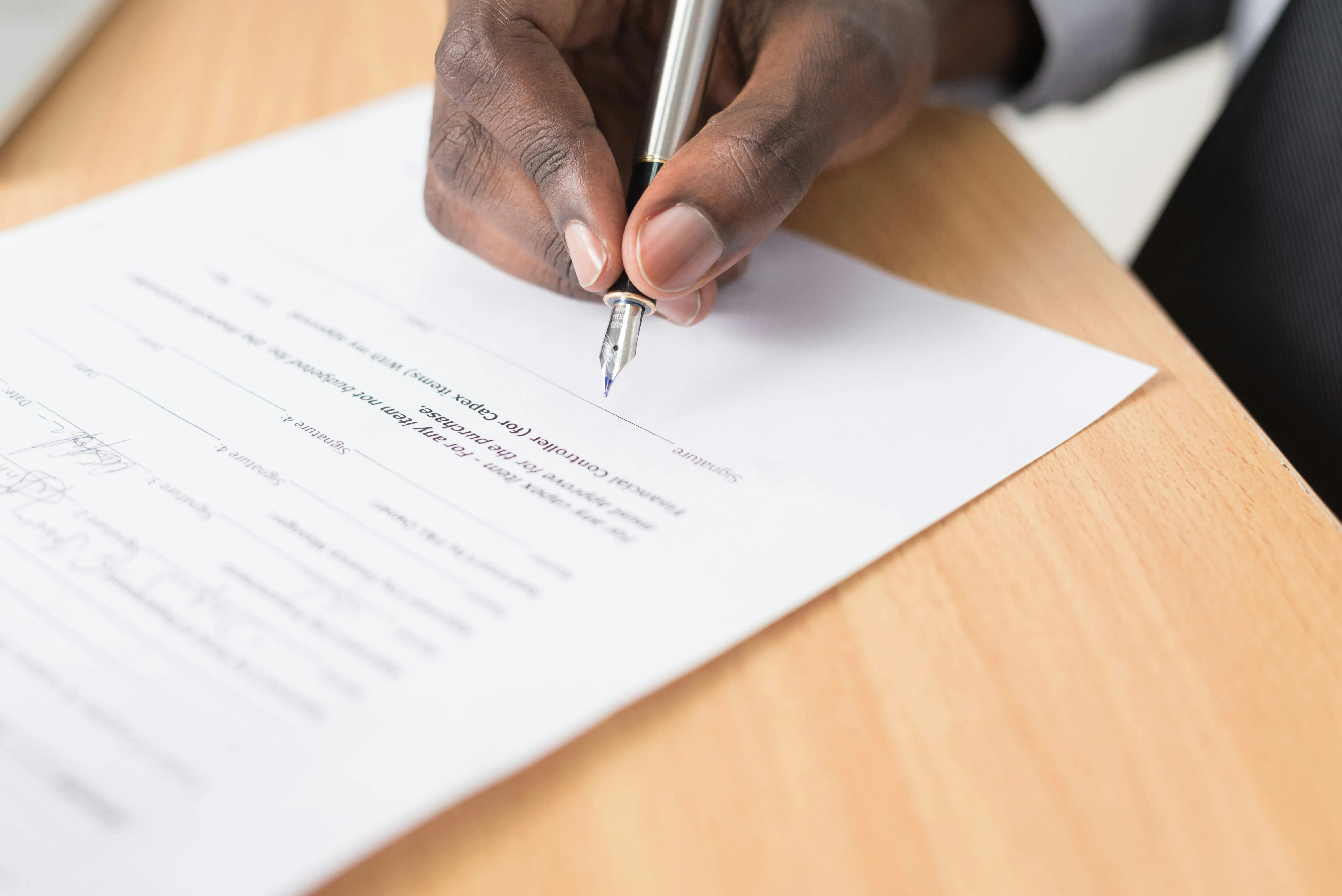 Signature d'un document de crédit au stylo plume sur un bureau